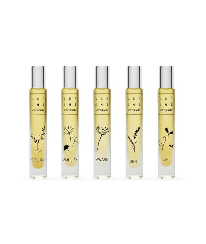 Lineup of five Serene Bodyhealth essential oil rollerballs: Ground, Amplify, Aware, Rest, and Lift.