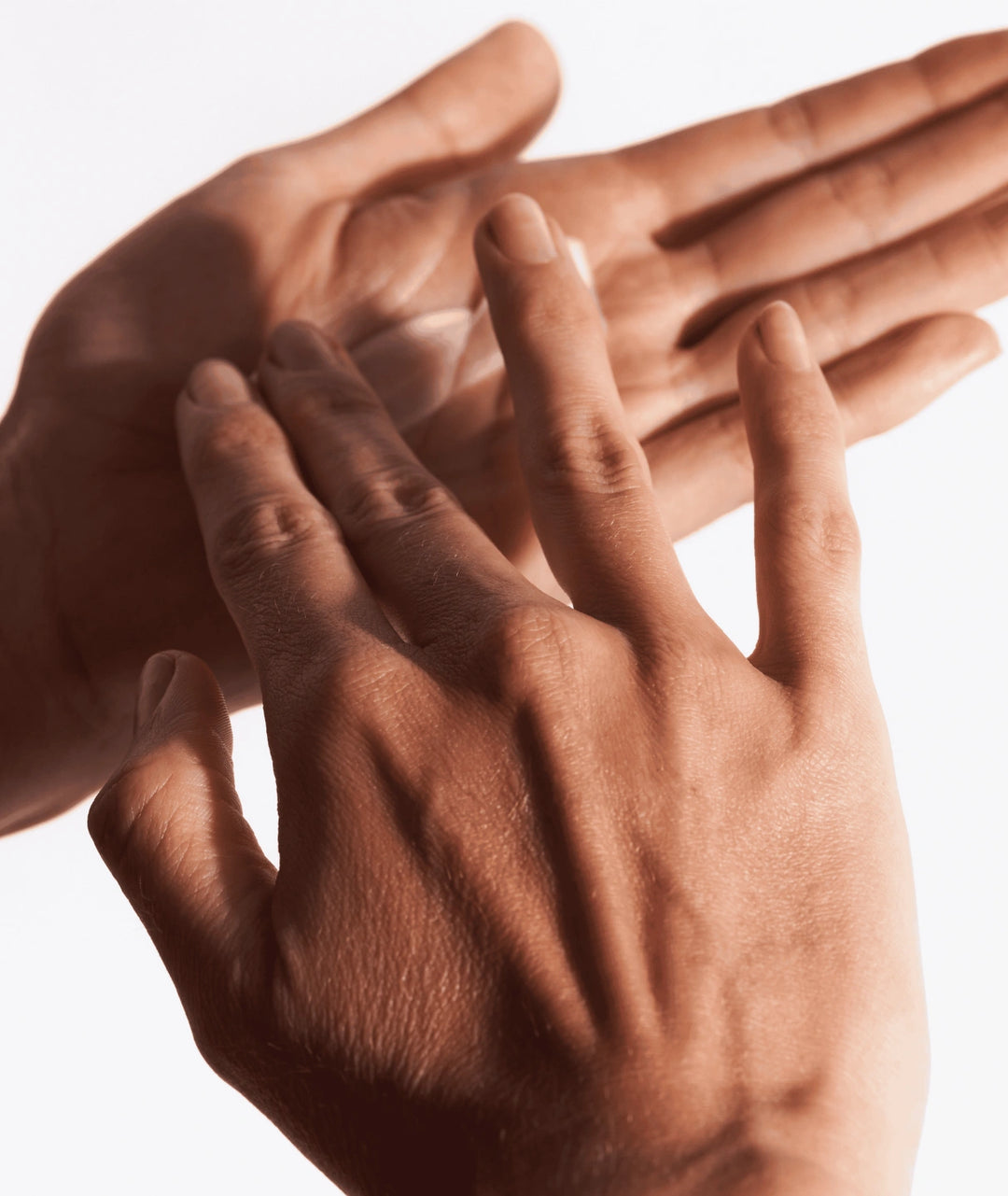 Applying Skoop Hand Hero Antiperspirant Dry Touch Hand Cream on hands, sweat-control hand moisturiser formulated to help reduce excess moisture, improve grip