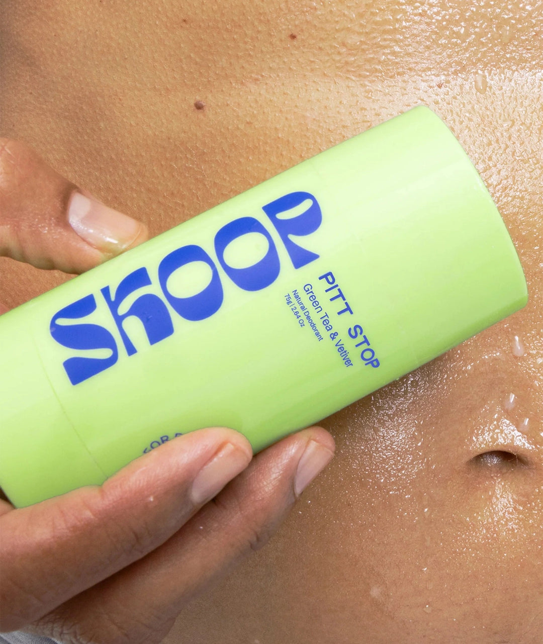 Skoop Pitt Stop Green Tea & Vetiver Natural Deodorant held against hydrated skin, natural deodorant stick formulated with plant-based ingredients for fresh underarms and all-day confidence.