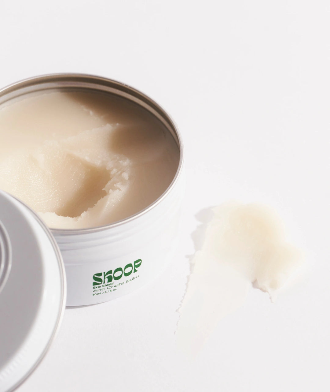 Skoop Skin Shield Anti-Chafe Balm open tin showing smooth balm texture, natural anti-chafing body balm designed to reduce friction, prevent skin irritation and support comfortable movement during exercise and everyday wear.