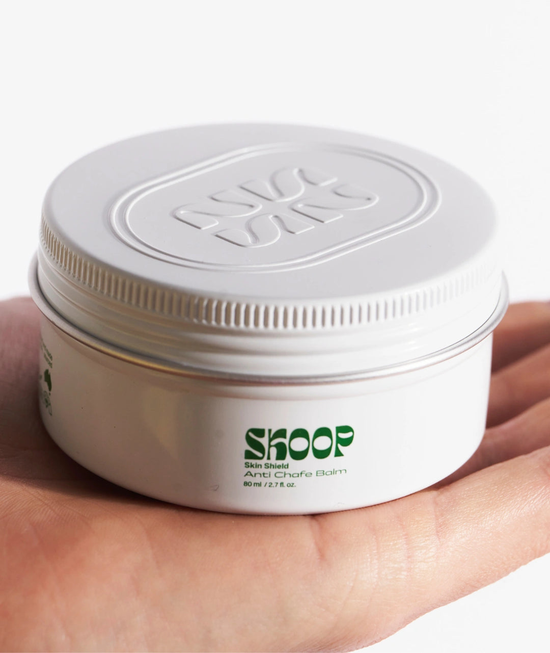 Skoop Skin Shield Anti-Chafe Balm in reusable aluminium tin held in hand, anti-friction balm for runners, walkers, cyclists and active lifestyles seeking long-lasting chafe protection.