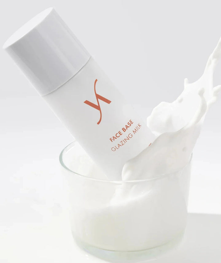 VANI-T Face Base Glazing Milk displayed with creamy milk splash highlighting its nourishing, glow-boosting formula for achieving a hydrated glass skin effect.