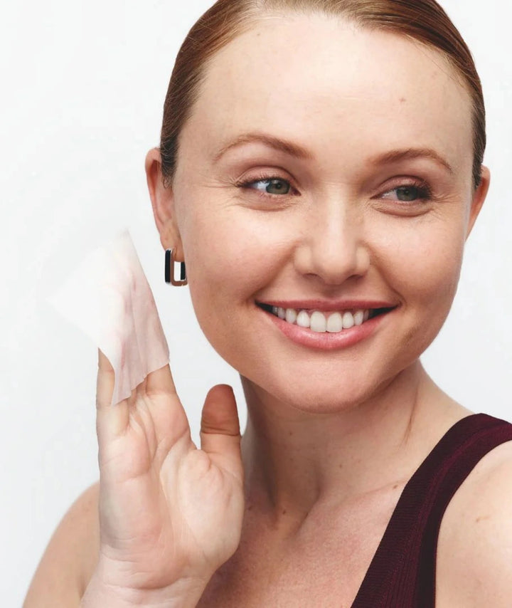 Woman holding Wrinkles Schminkles Polishing Peel Pad before applying to cleansed skin