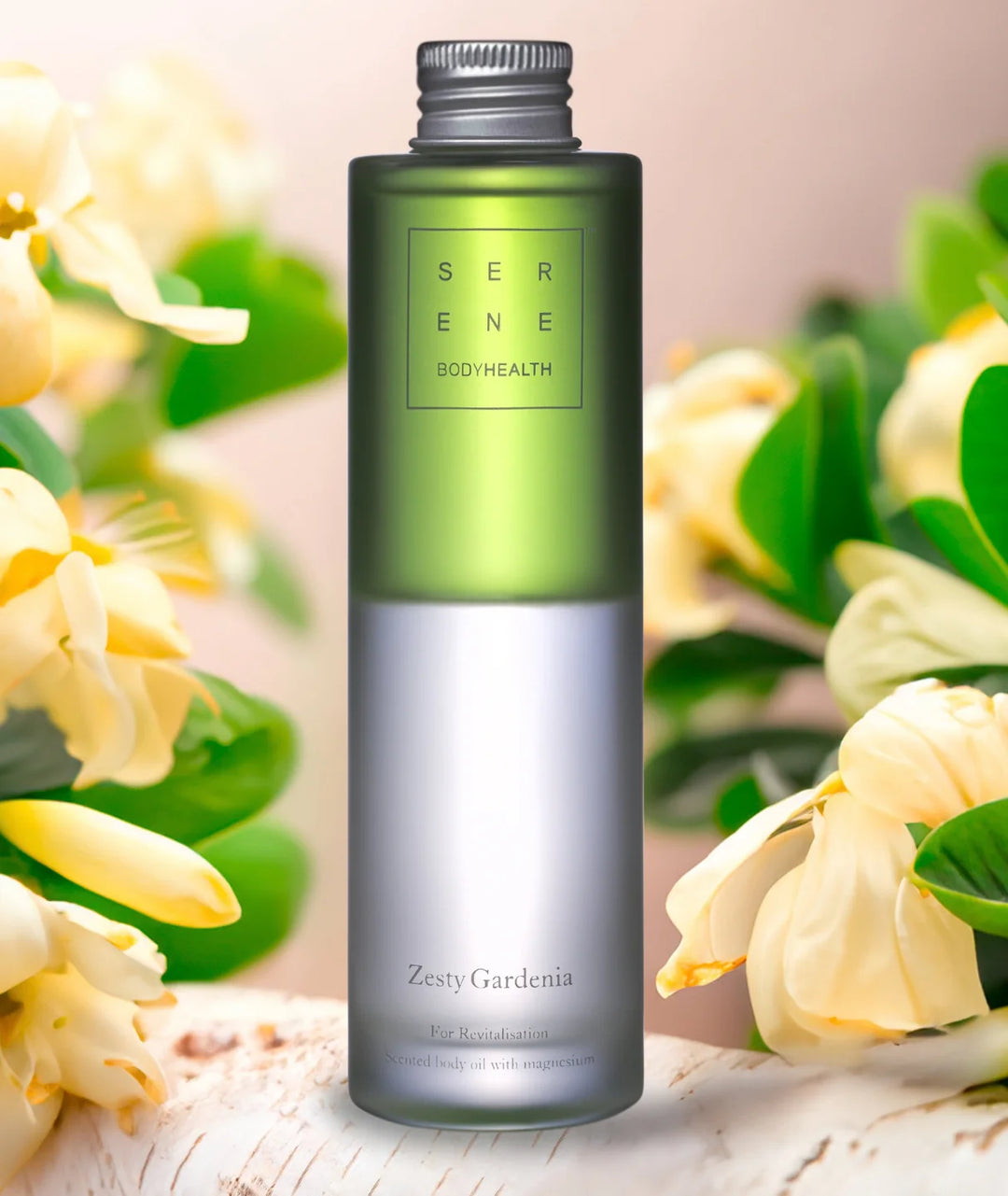 Zesty Gardenia scented magnesium body oil bottle by Serene Bodyhealth framed by white gardenia flowers.